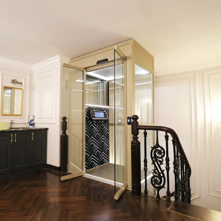 The Cibes Lift V80 home elevator with an open glass door, showing its geometric patterned interior, installed in a luxurious home with dark wood floors and classic decor.