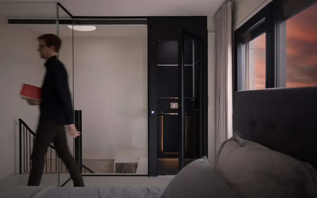 Modern bedroom with a compact home lift installed near a staircase, designed for quiet and seamless integration.