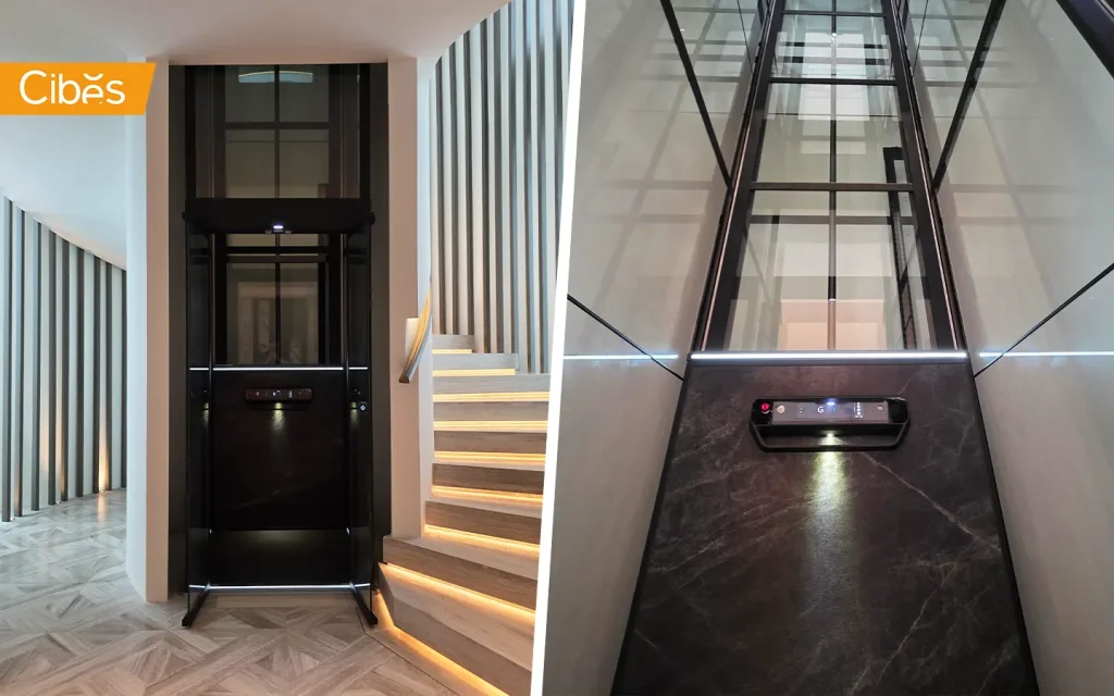 Cibes V80 platform home lift installed beside a staircase in a modern villa interior with illuminated steps.