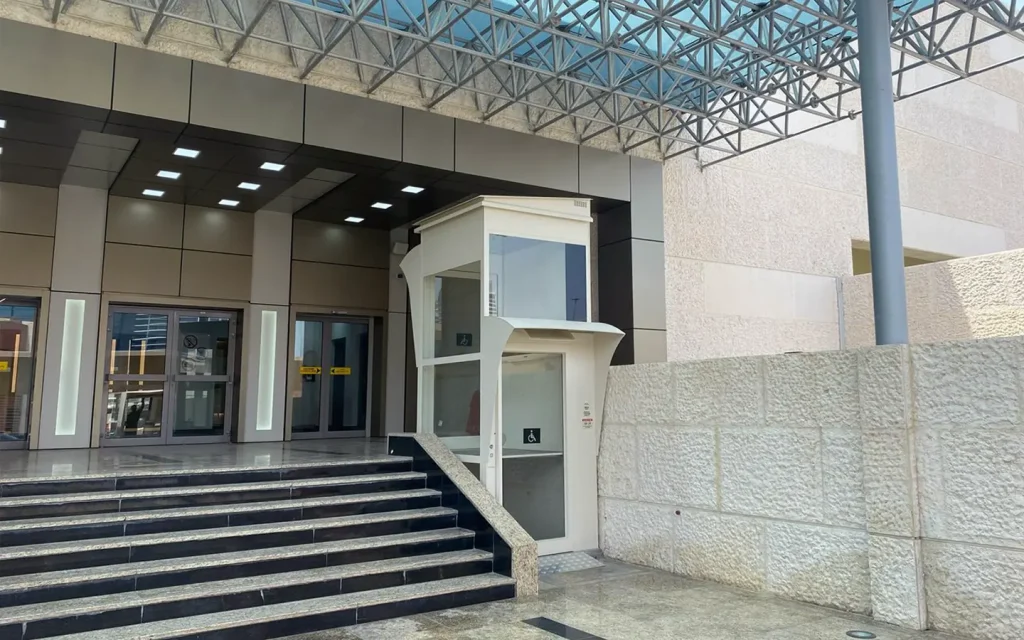Cibes Voyager outdoor platform lift installed beside building entrance stairs in Abu Dhabi.